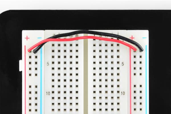 Jumper wires connecting both sides of the power rails